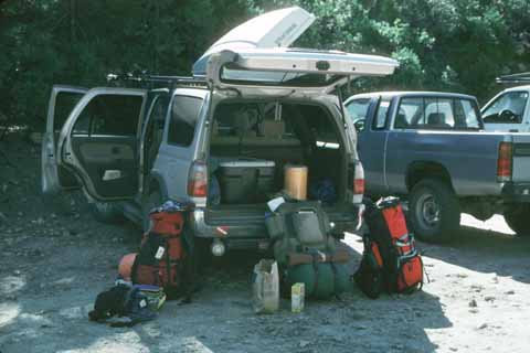 Photo, packs leaning against a car.