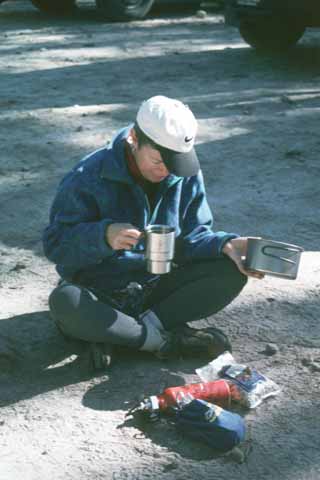 Photo, person sorting gear.