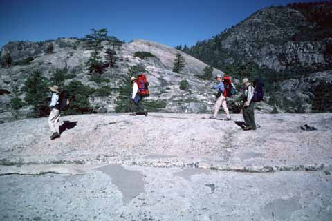 Photo, people on rock ridge.