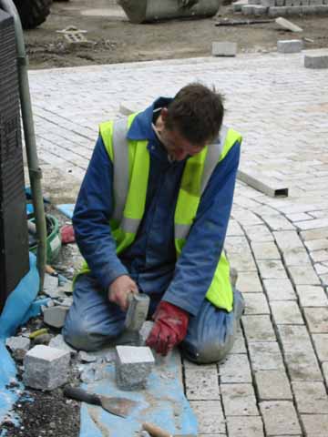 Photo, man cutting stones