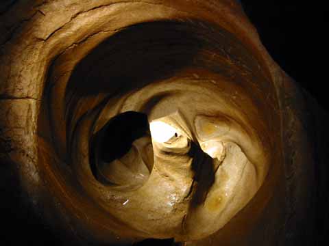 Photo, tub-sized hole in cave floor