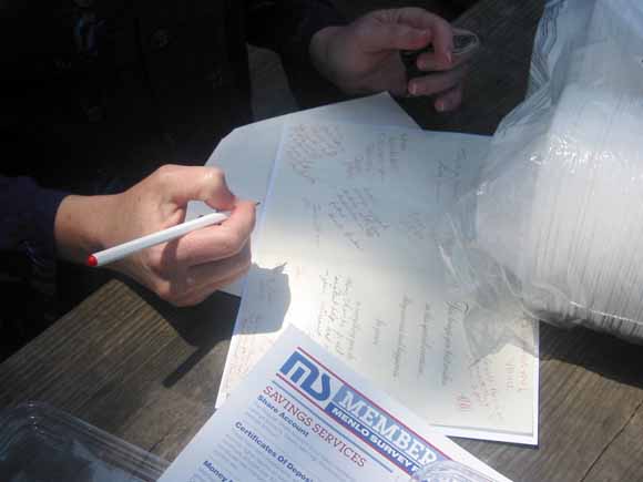 photo of person's hand writing in card.