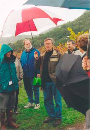 Photo of David lecturing in the rain under a golf umbrella