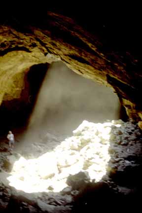 photo of inside of lava-flow-tube cave with light coming through a thirty-foot collapse in the roof