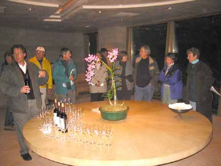 Photo of group around serving table with wine