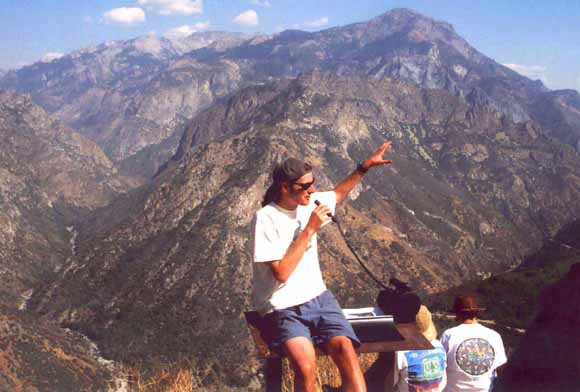 photo of Greg lecturing; Sierra peaks in background