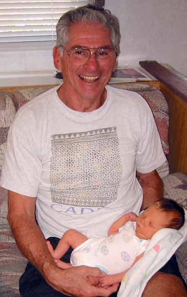 photo of George with his grandbaby in his lap
