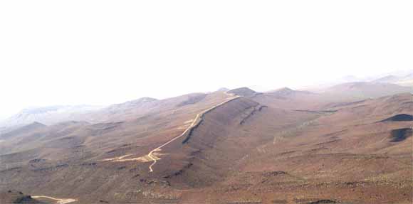 photo of surface of mars showing water-cut banks