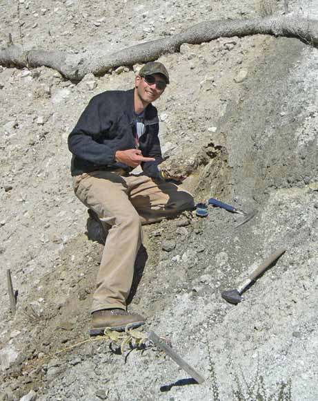 photo of Joe on a slope with his two hammers and a willow wattle