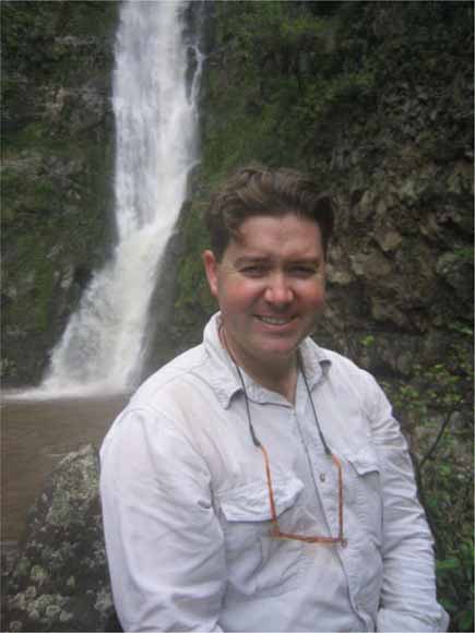 photo of Jonathan standing in front of a waterfall