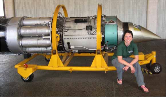 photo of Darcy sitting in front of a jet engine