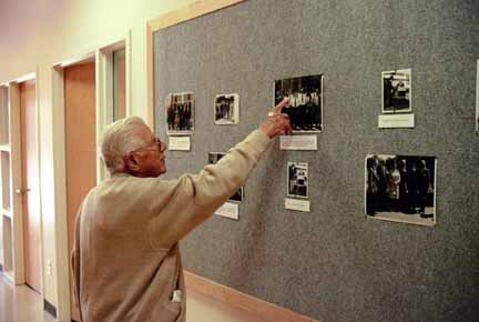 Bob viewing photos on bulletin board