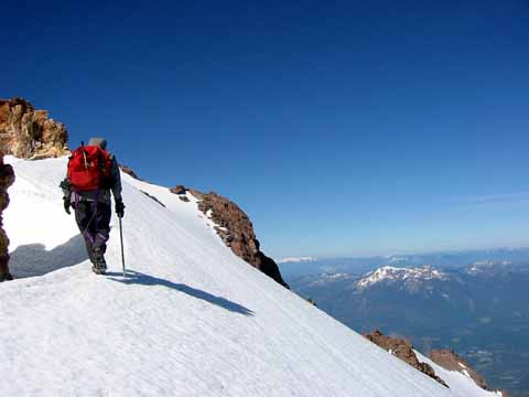 Photo, climber with ice ax and pack.