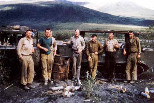 photo, seven men in front of tracked vehicle the size of a Volkswagon